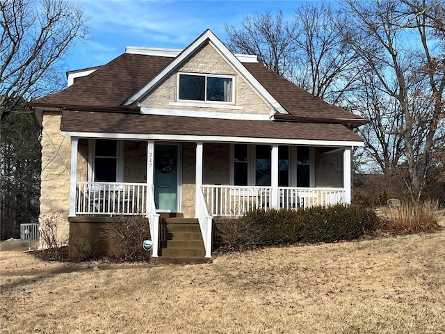 view of front of house with a porch and a front lawn