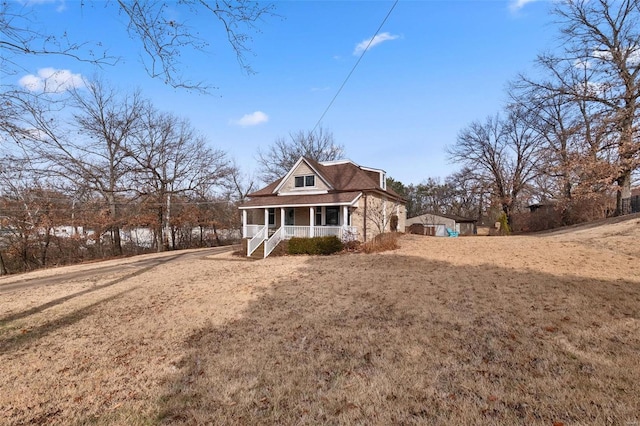 exterior space featuring a yard and covered porch