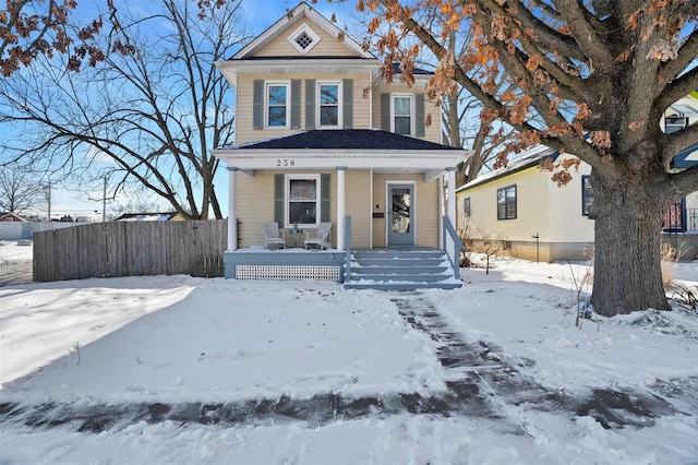 view of front of property with covered porch and fence