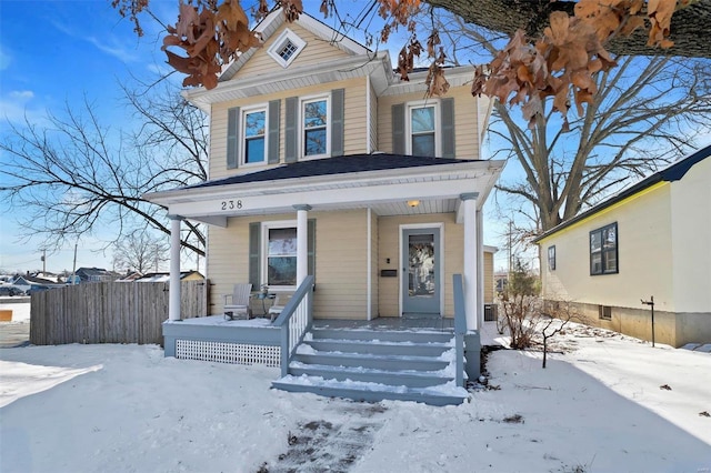 view of front of property featuring a porch and fence