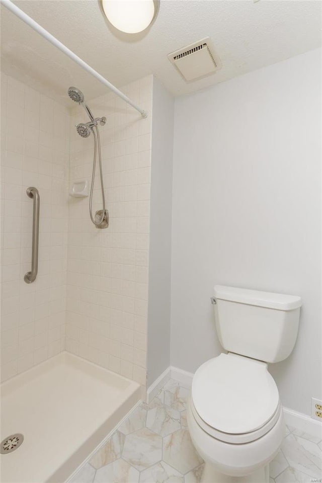 full bath featuring baseboards, visible vents, marble finish floor, and a stall shower