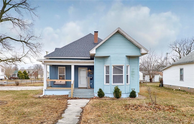 bungalow-style home with a front lawn and a porch