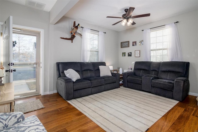 living room featuring ceiling fan and wood-type flooring