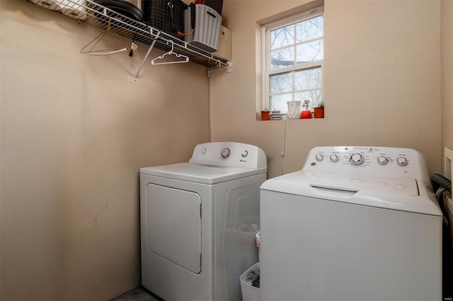 clothes washing area with separate washer and dryer