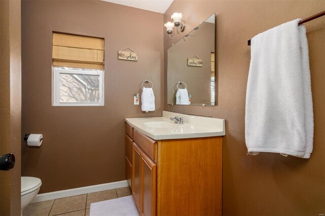 bathroom featuring vanity, tile patterned floors, and toilet