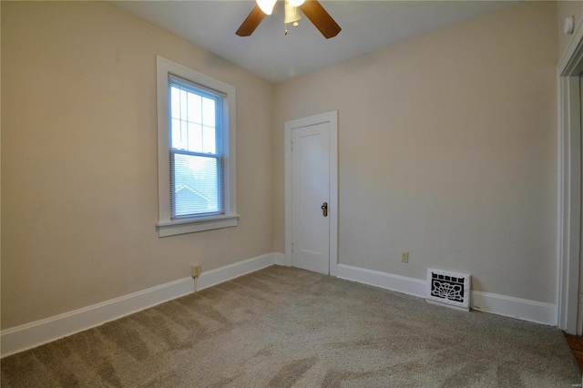 carpeted empty room featuring ceiling fan