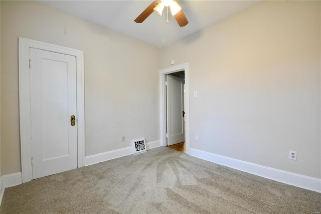 spare room with light colored carpet and ceiling fan