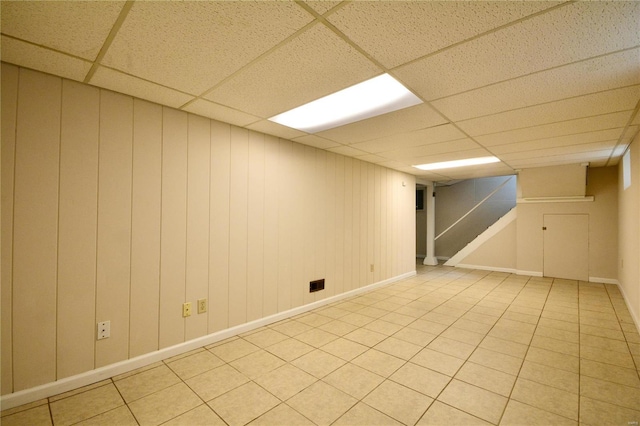 basement with a paneled ceiling