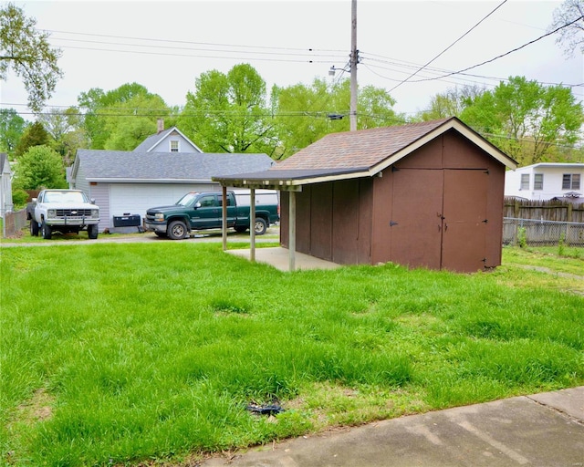 view of yard with a carport and a shed