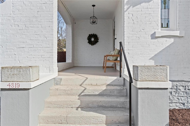 view of exterior entry featuring brick siding