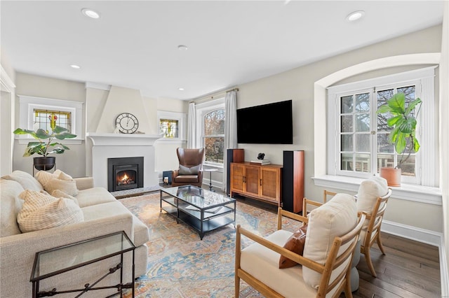 living room with baseboards, a fireplace, wood finished floors, and recessed lighting