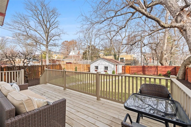 wooden terrace featuring an outdoor structure, a fenced backyard, and a residential view