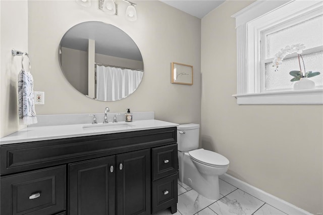 full bath featuring marble finish floor, vanity, toilet, and baseboards