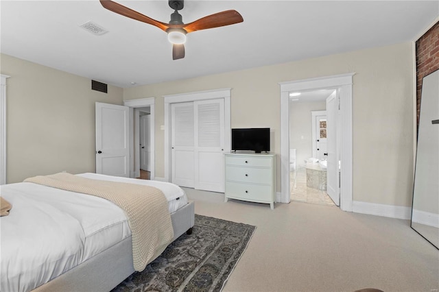 bedroom with a closet, carpet flooring, visible vents, and baseboards