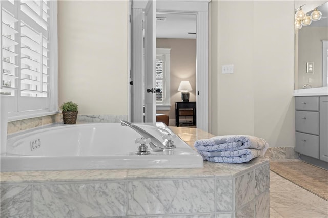 ensuite bathroom with a garden tub, visible vents, connected bathroom, and vanity