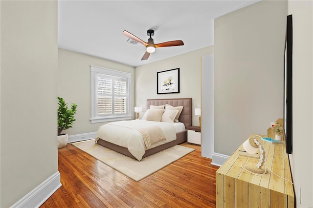 bedroom with baseboards and wood finished floors