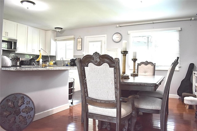 dining space featuring dark hardwood / wood-style floors