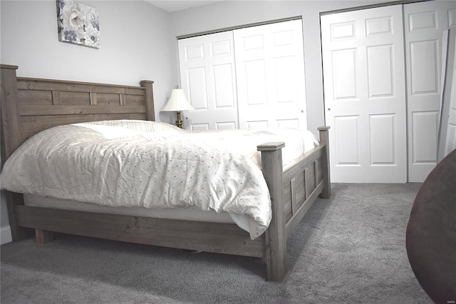 carpeted bedroom featuring multiple closets