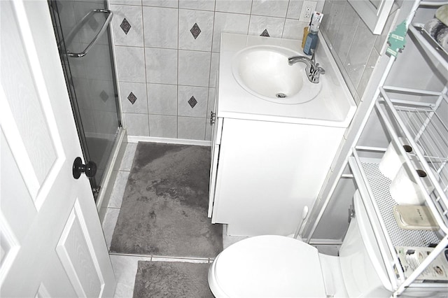 bathroom featuring vanity, tile patterned floors, toilet, and walk in shower