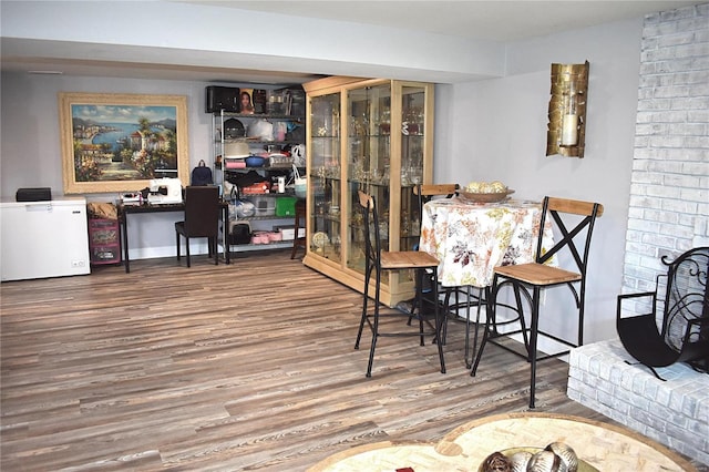 dining space with hardwood / wood-style flooring