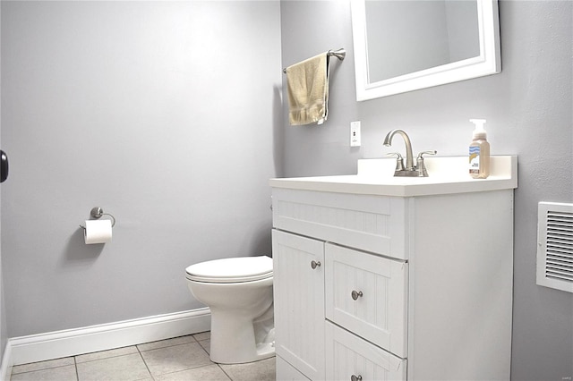 bathroom featuring vanity, tile patterned flooring, and toilet