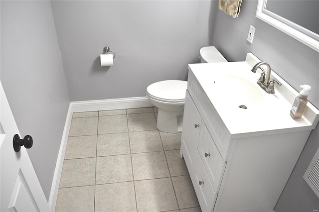 bathroom with tile patterned flooring, vanity, and toilet