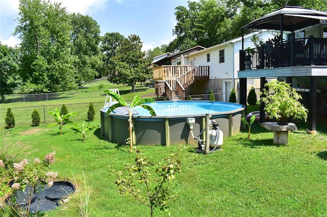 view of swimming pool with a yard and a deck