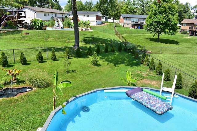 view of pool featuring a yard