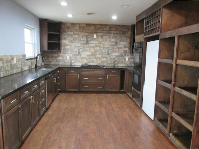 kitchen featuring dishwasher, sink, dark wood-type flooring, and backsplash