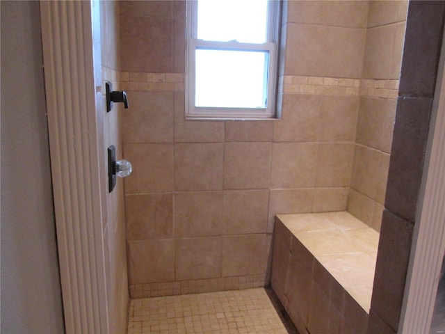 bathroom with tiled shower