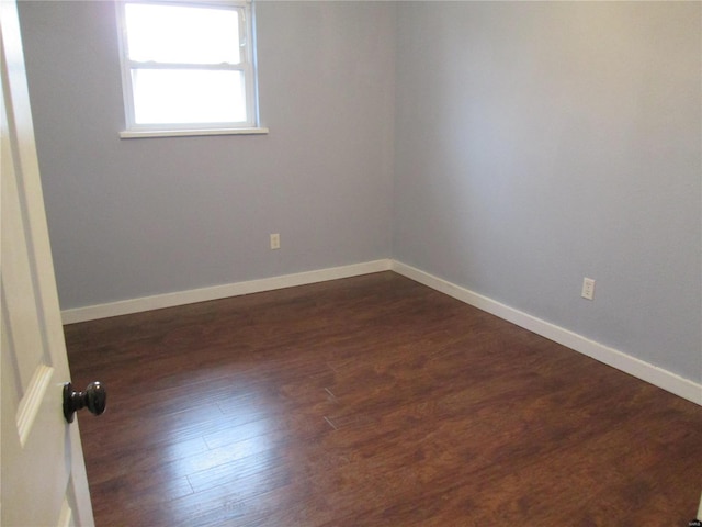 spare room featuring dark hardwood / wood-style flooring