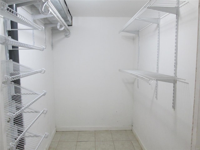 spacious closet with light tile patterned floors