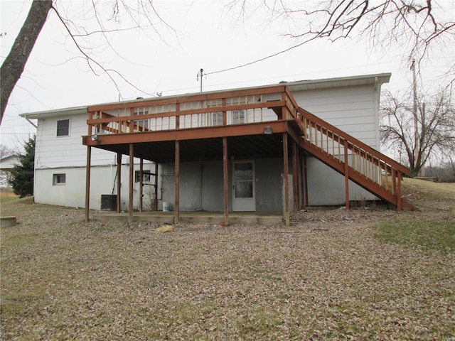 back of house with a wooden deck and central air condition unit