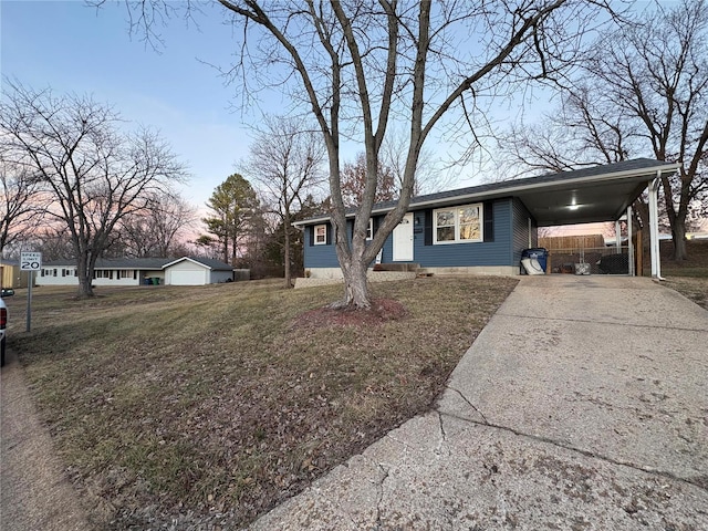 single story home featuring a carport and a lawn