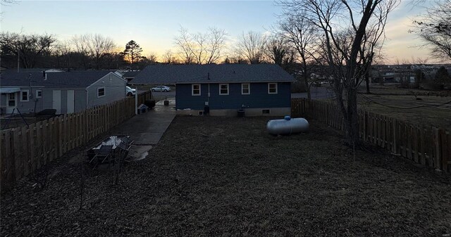 view of back house at dusk