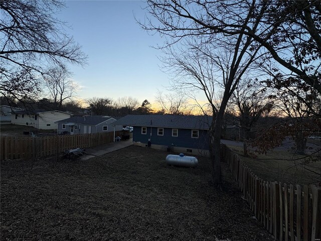 view of yard at dusk