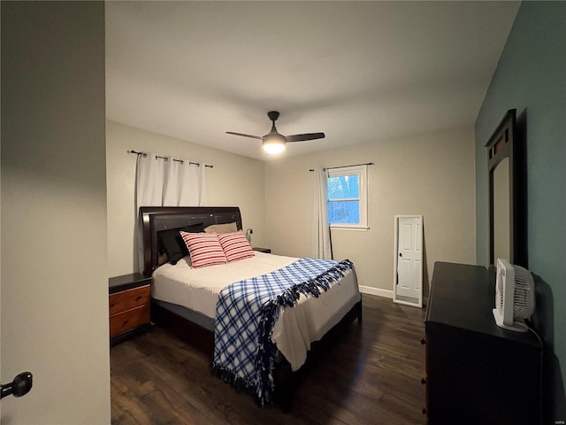 bedroom with dark hardwood / wood-style floors and ceiling fan