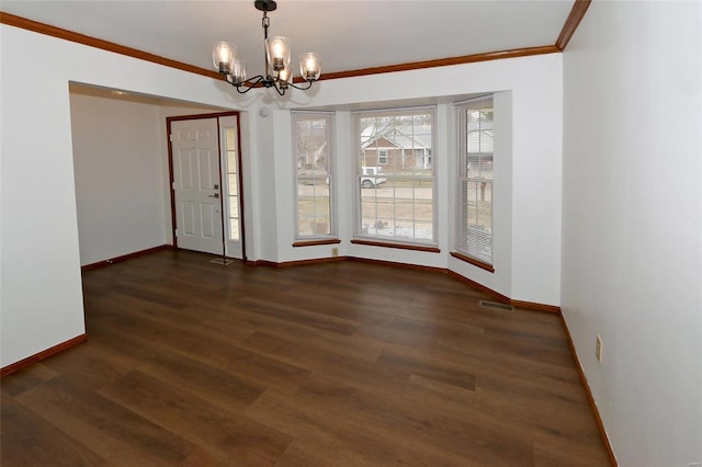 unfurnished room with ornamental molding, dark hardwood / wood-style flooring, and a notable chandelier