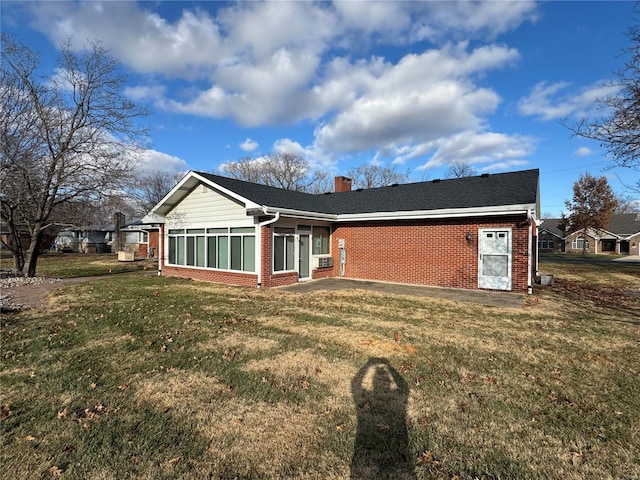 back of property featuring a lawn