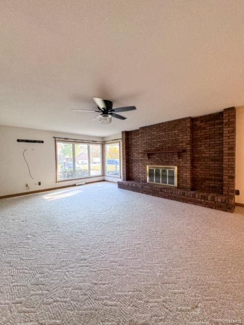 unfurnished living room with a fireplace, a textured ceiling, carpet, and ceiling fan