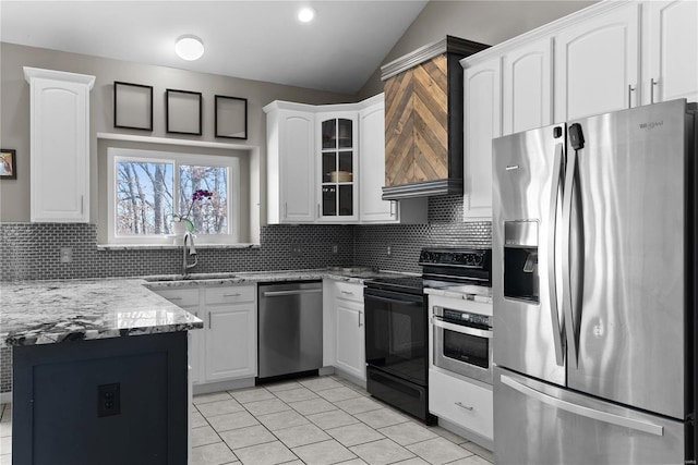 kitchen with sink, tasteful backsplash, stainless steel appliances, light stone countertops, and white cabinets