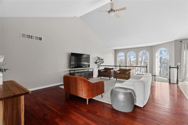 living room featuring ceiling fan, dark hardwood / wood-style floors, and high vaulted ceiling