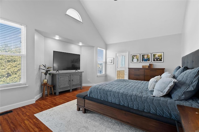 bedroom with dark hardwood / wood-style flooring and high vaulted ceiling