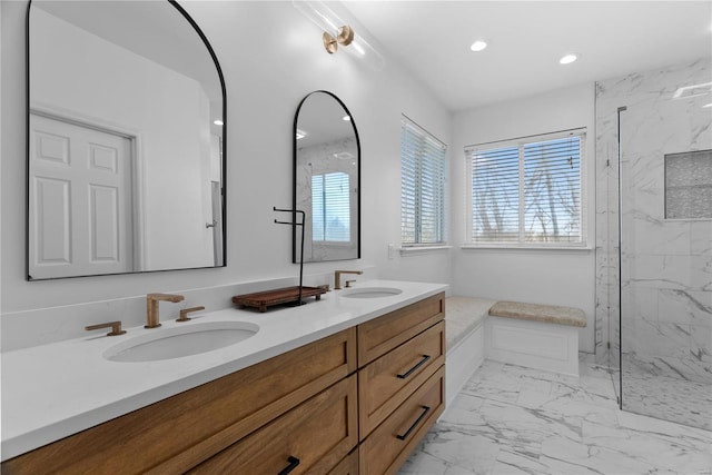 bathroom with vanity and a tile shower