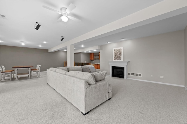 living room featuring light carpet and ceiling fan