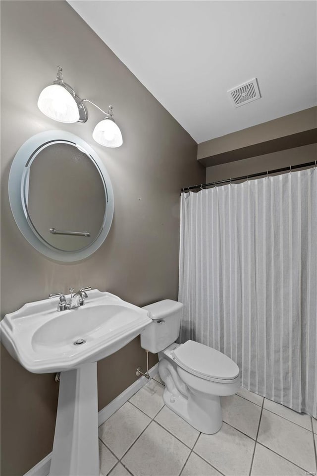 bathroom featuring tile patterned floors and toilet