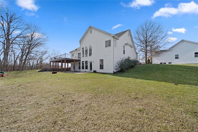 back of house featuring a wooden deck and a lawn