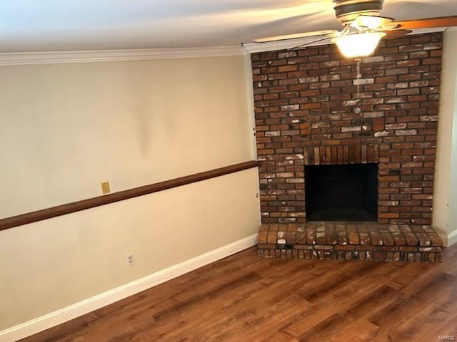 unfurnished living room featuring hardwood / wood-style flooring, ornamental molding, a brick fireplace, and ceiling fan