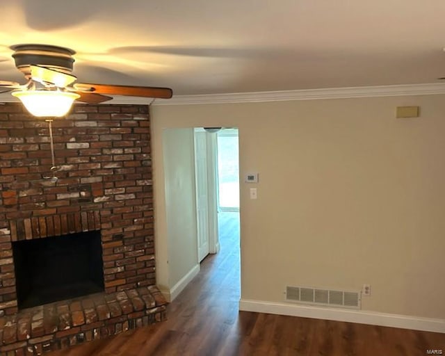 unfurnished living room with crown molding, a brick fireplace, hardwood / wood-style floors, and ceiling fan