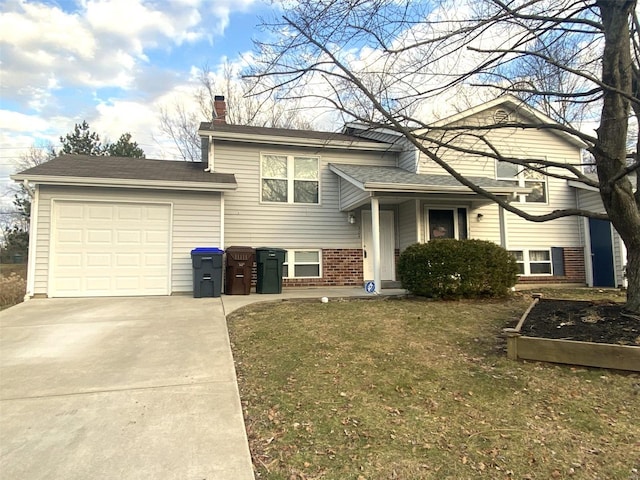 tri-level home featuring a garage and a front lawn